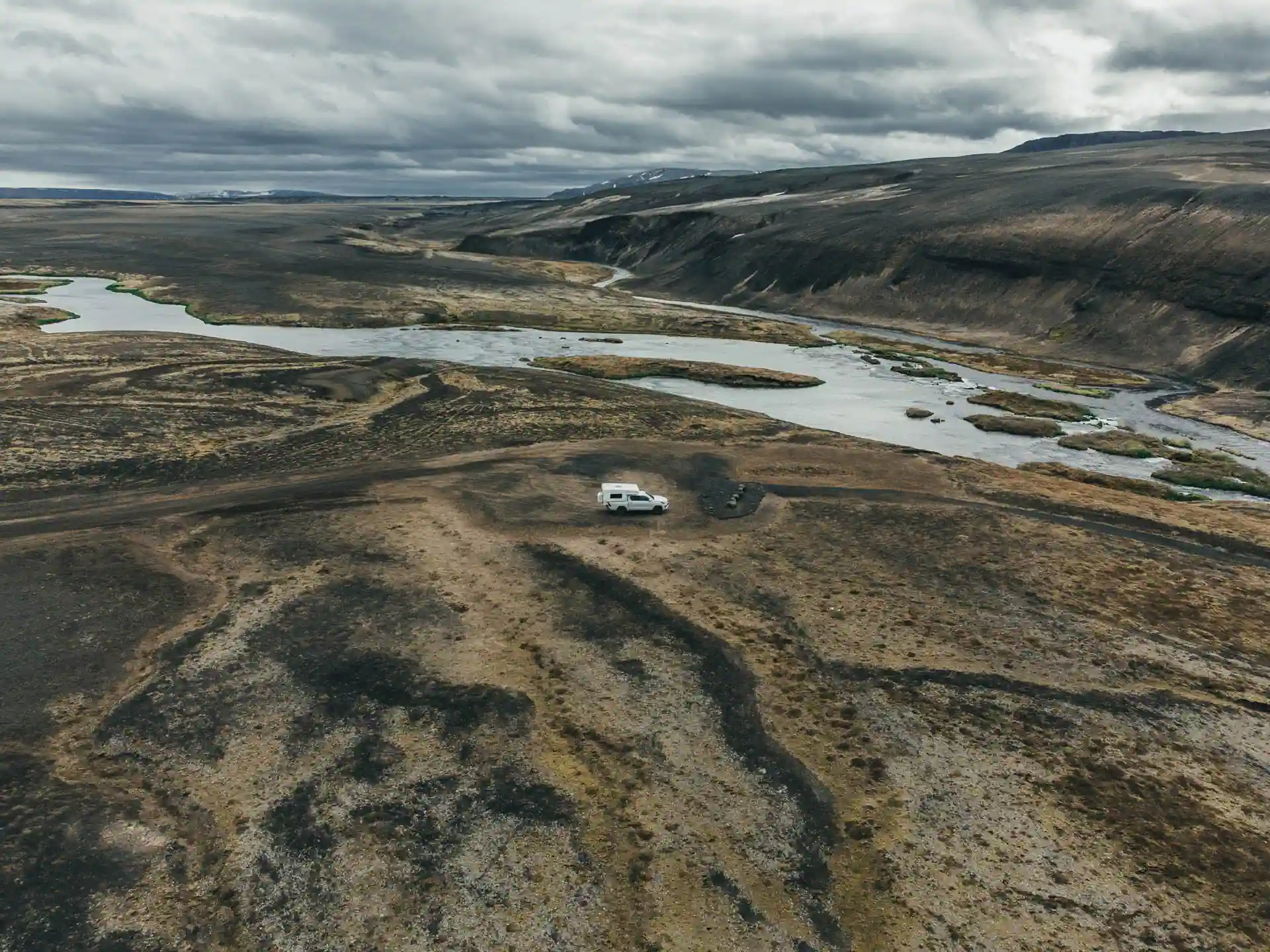 4x4 campervan Iceland parked in volcanic highlands overlooking river canyon