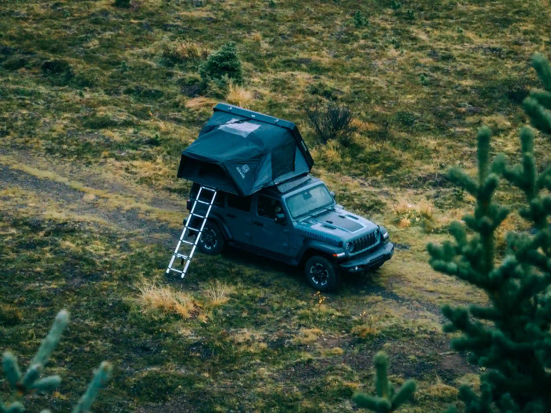Rooftop tent camper parked safely in remote Icelandic terrain.
