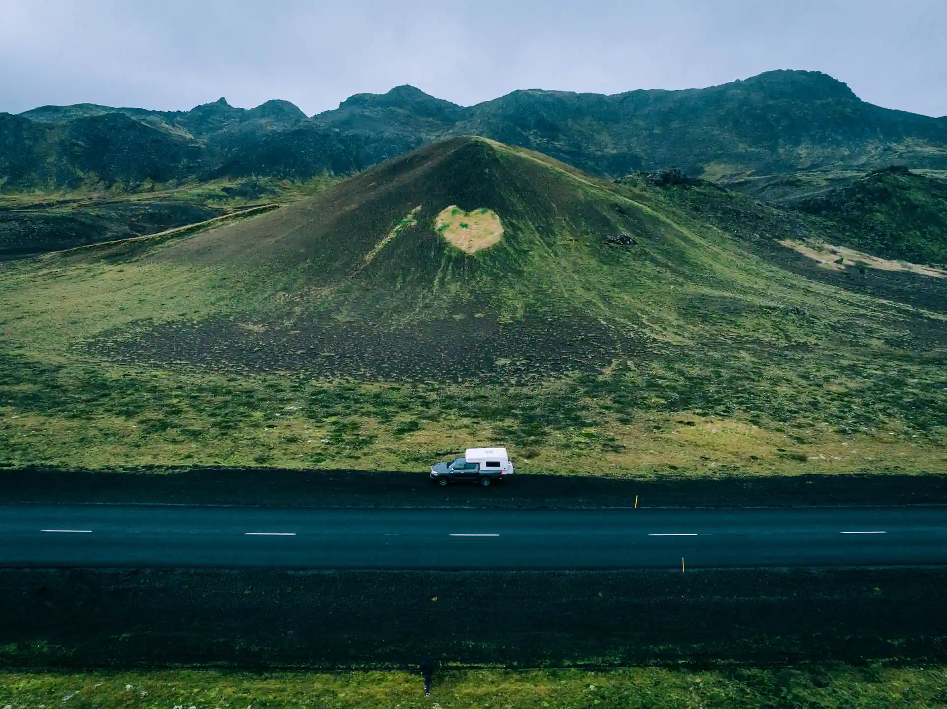 4x4 campervan driving past a volcanic hill in the Icelandic highlands