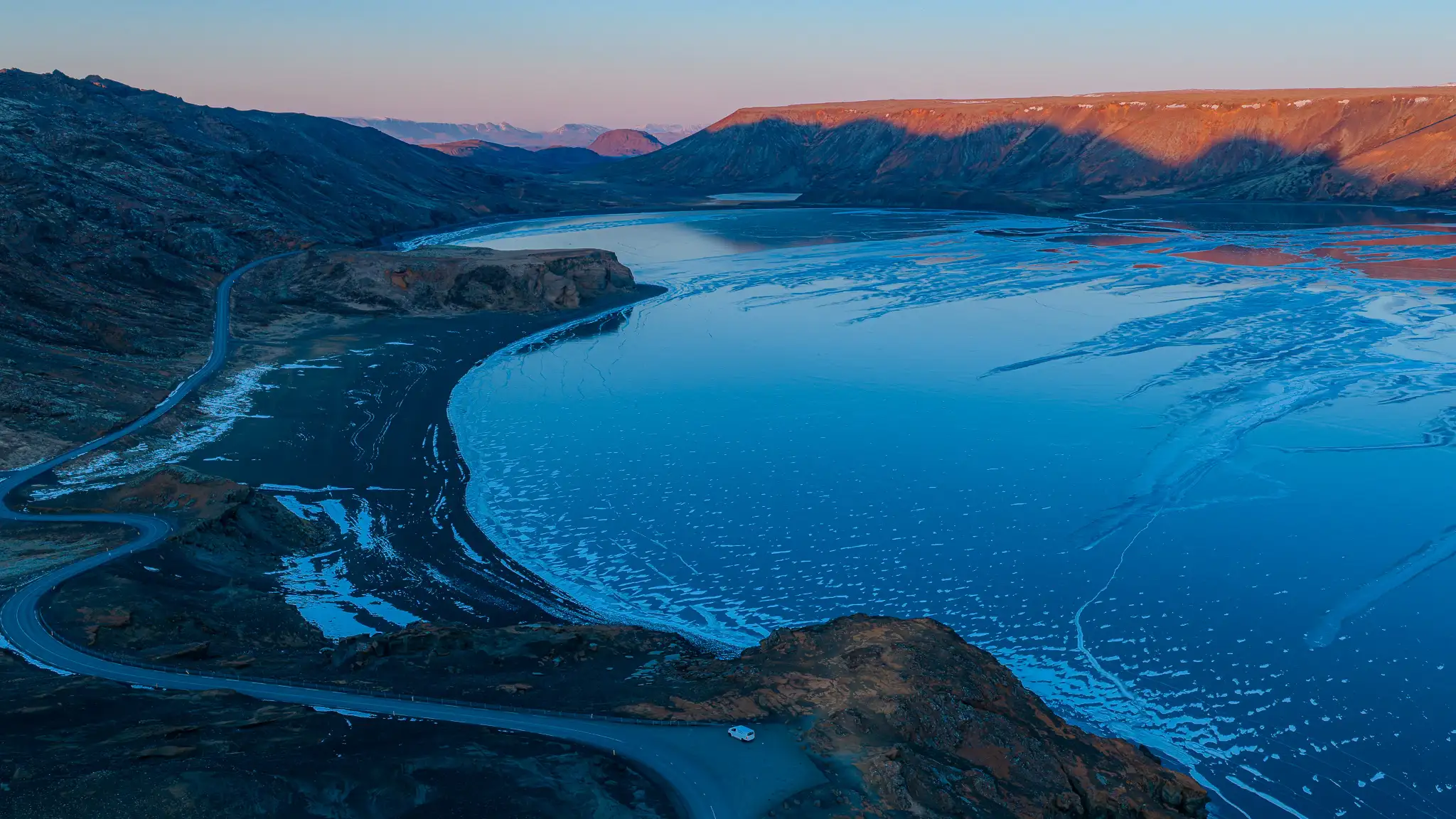 campervan parked along the Ring Road beside a fjord in East Iceland during sunset on an Iceland campervan road trip