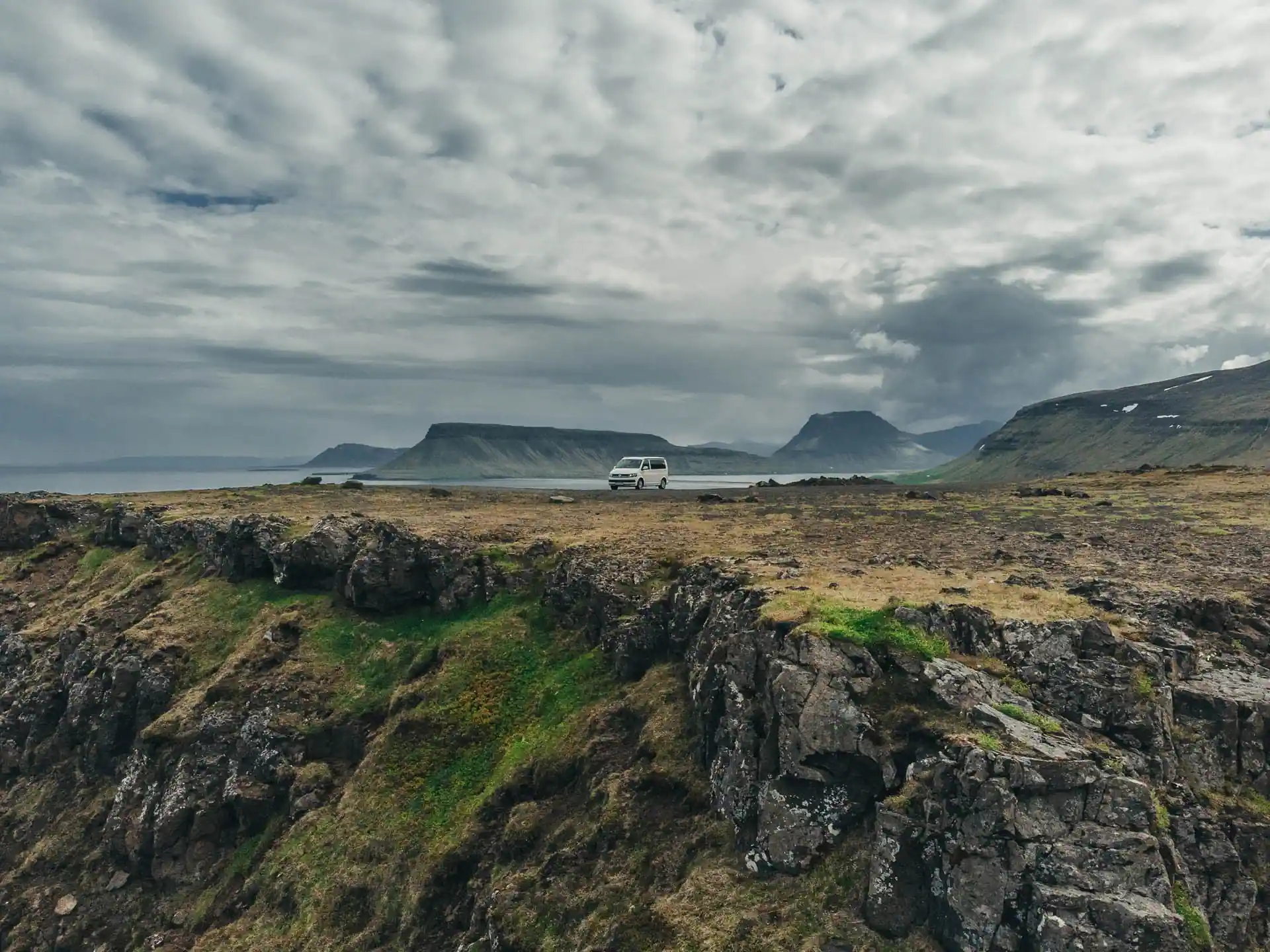 campervan parked in the wild landscape with a mountains and hill view